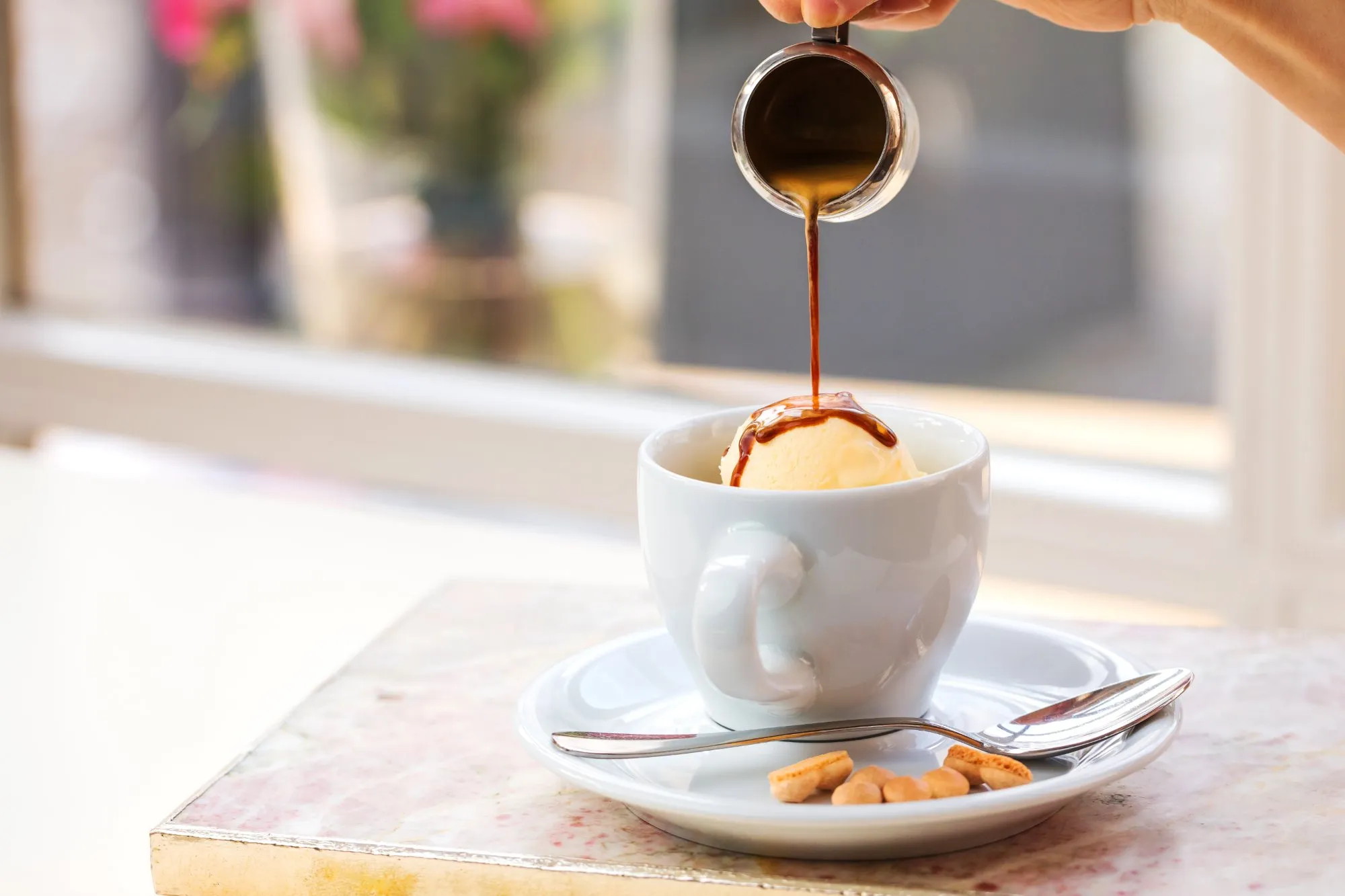Espresso being poured into a cup