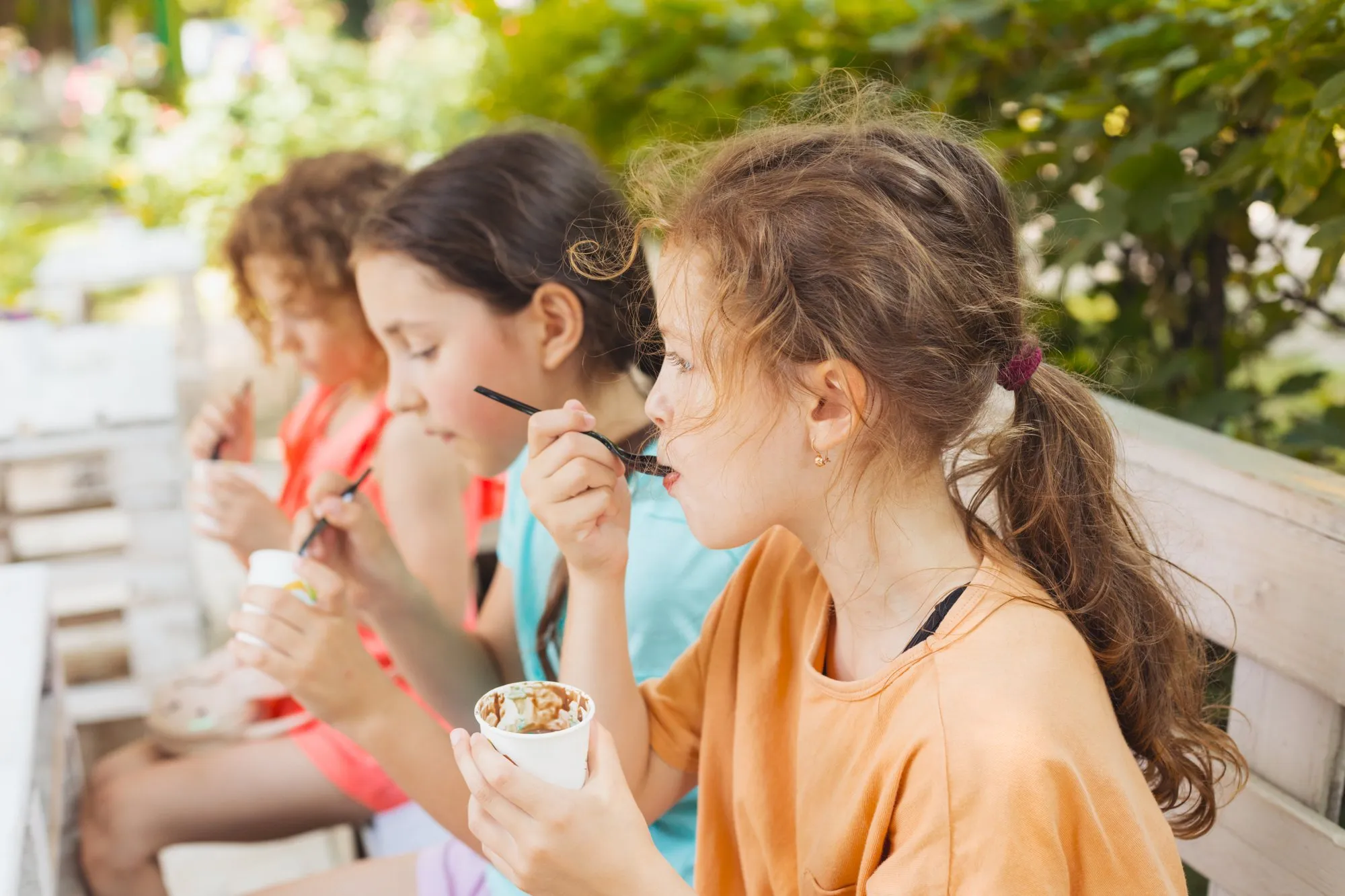 Kids eating ice cream together outside