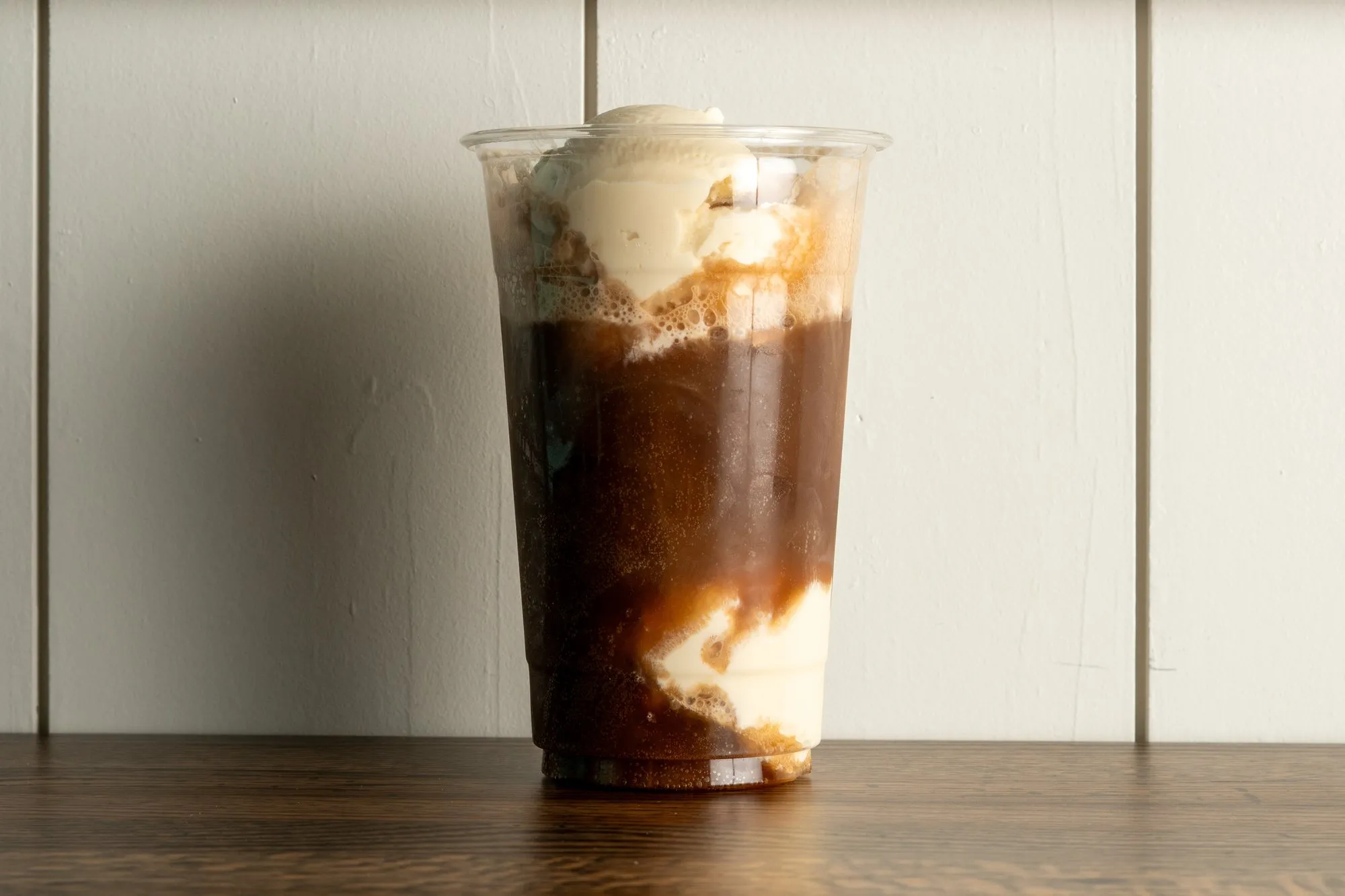 A root beer float in a tall glass